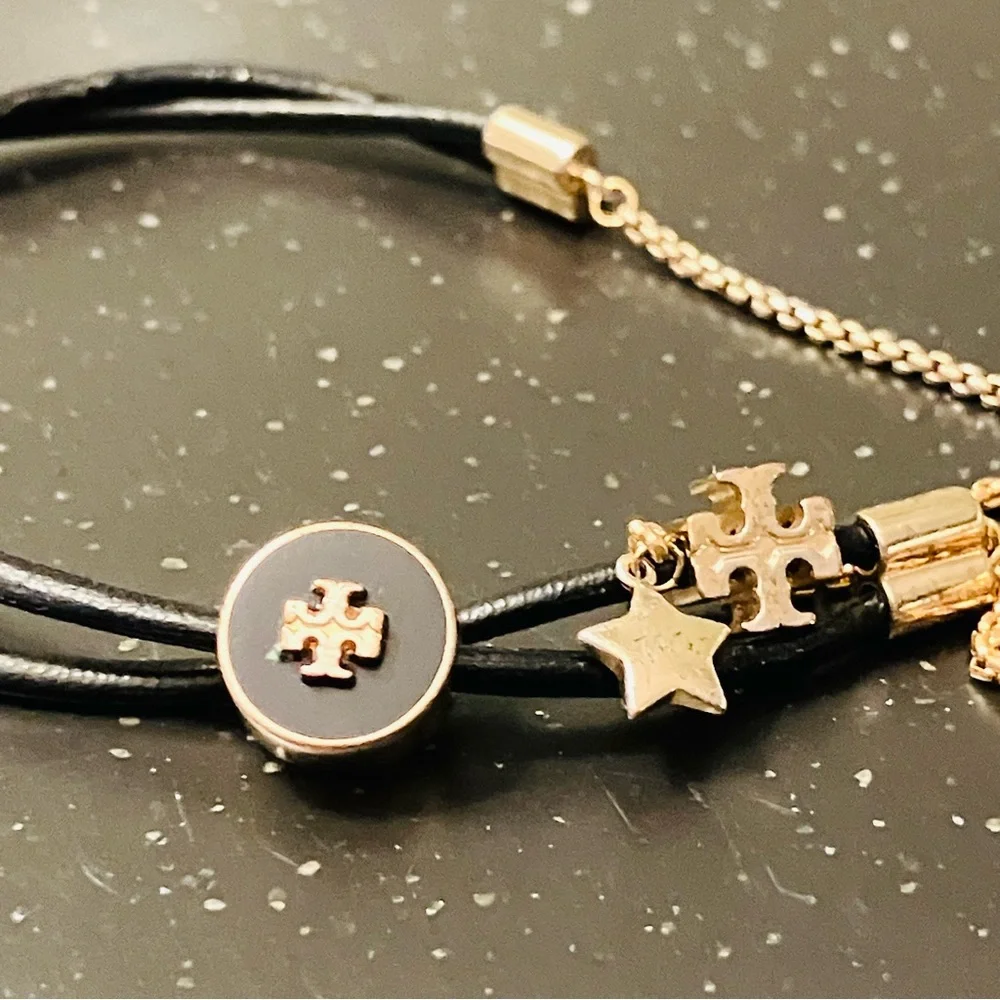 Tory Burch-Kira Double Leather Slider Bracelet in Black and Gold. Shows min wear